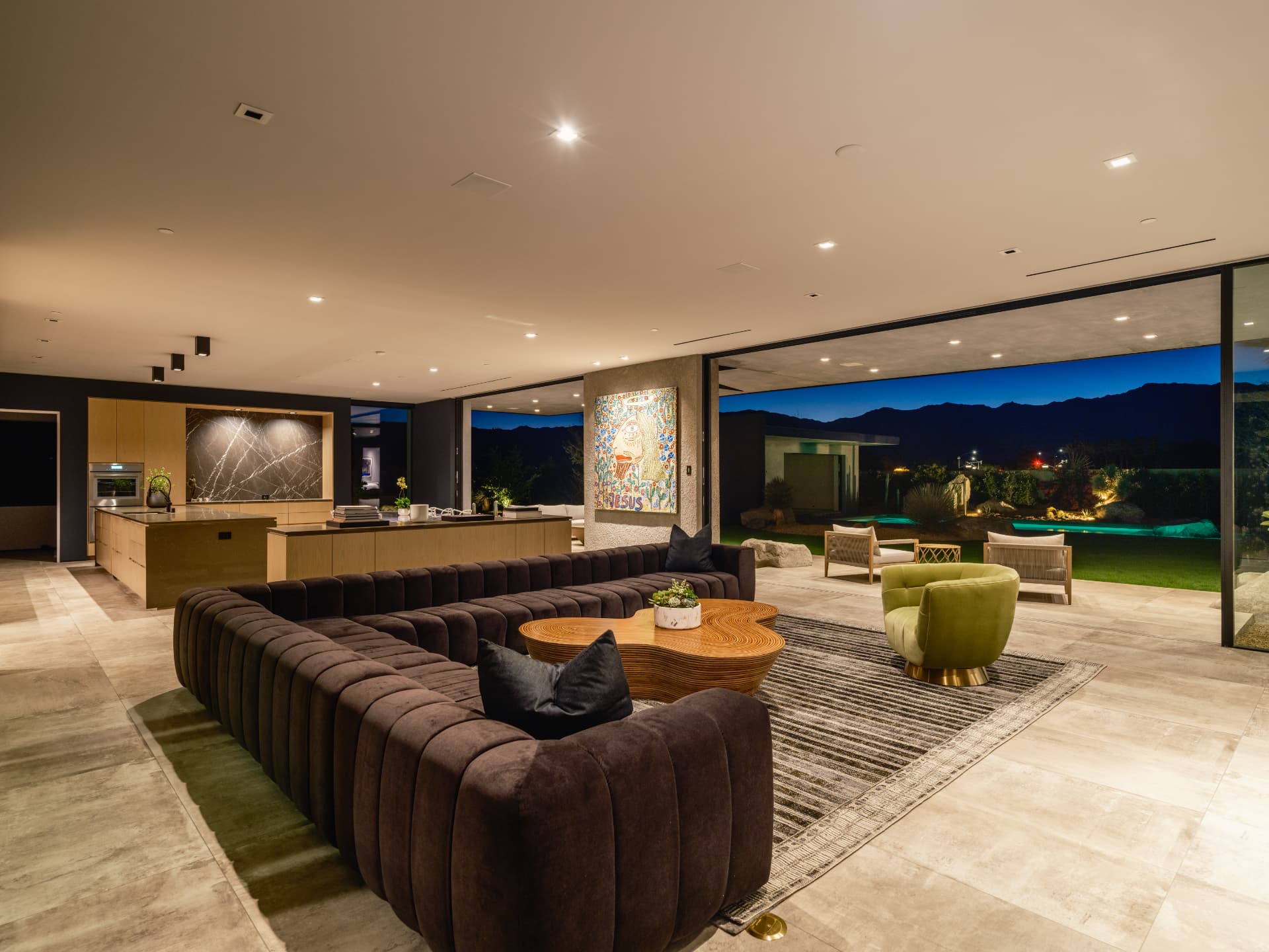 Open living room, kitchen and pool at night at 3 Echo Lane