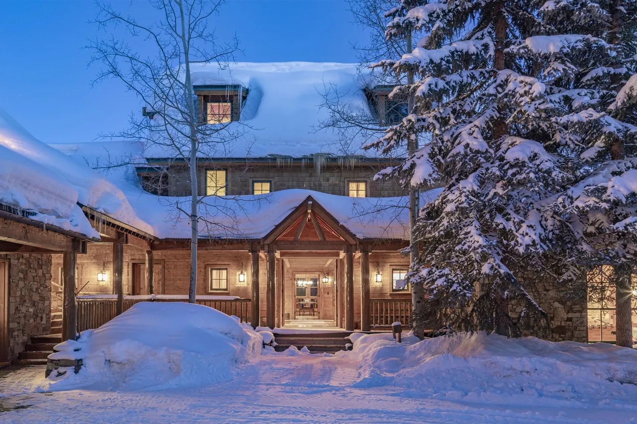 Snow-covered entrance at 115 Francisco Way at twilight
