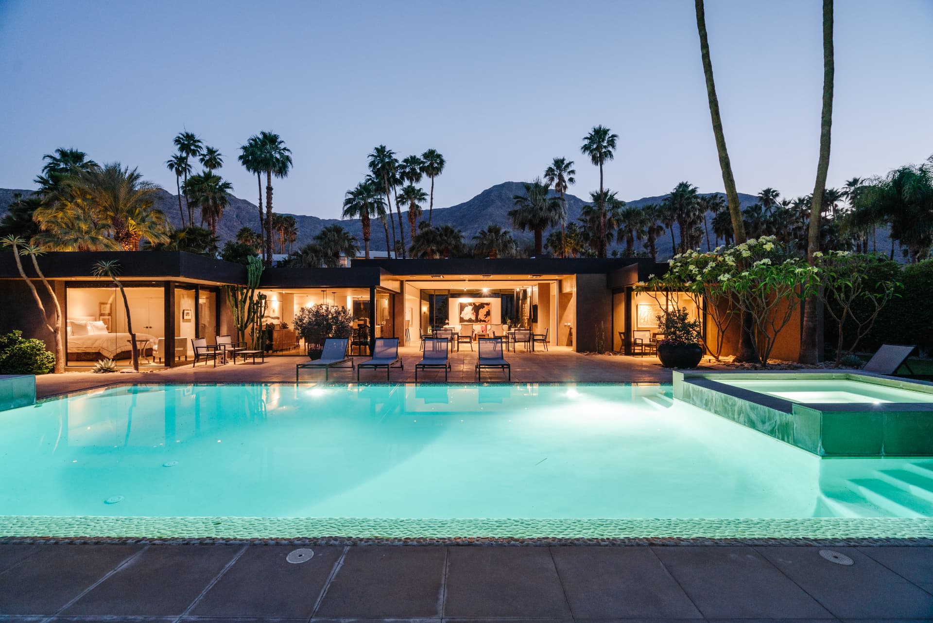 Pool and open living spaces at 70257 Calico at twilight